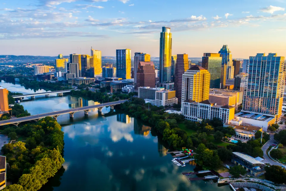 Aerial view at dusk of downtown Austin, Texas with river in foreground